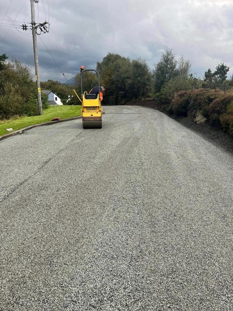 Rolling new surface dressing smooth at a farm in Scotland 