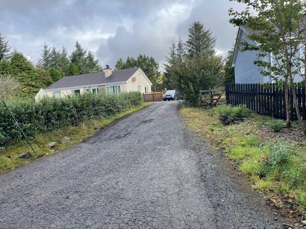 Weathered & worn farm road in Scotland BEFORE surface dressing work